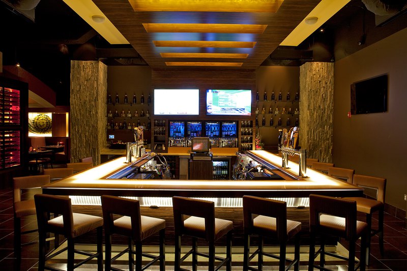 Custom millwork adds a rugged look to this stylish bar and complements the minimalist design.